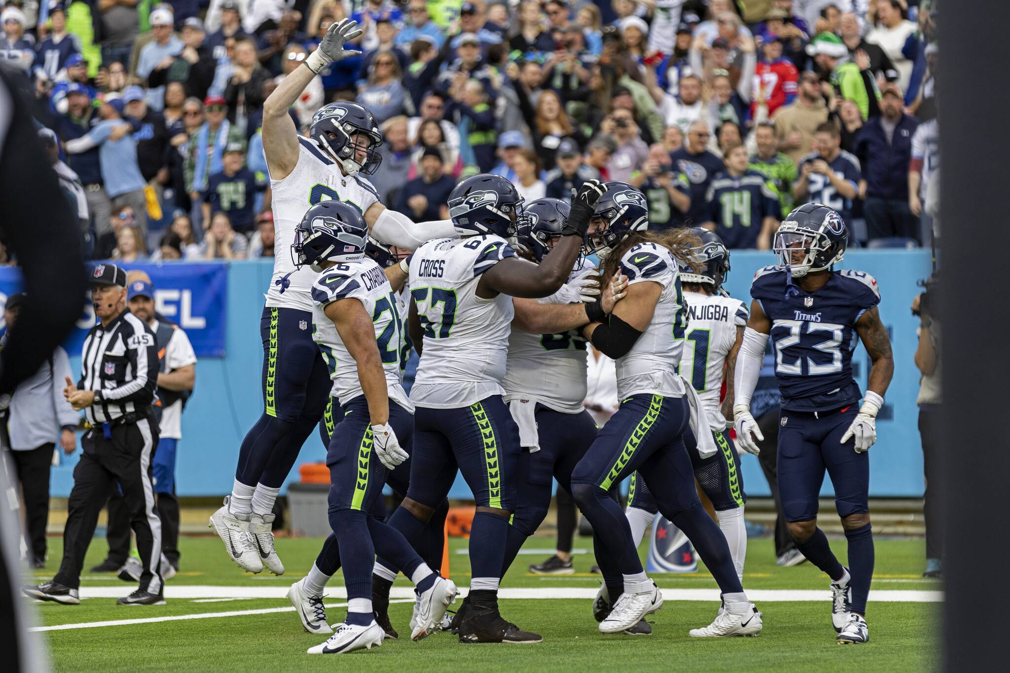 Seattle Seahawk players celebrate the game-wining touchdown with tight end Colby Parkinson (84) as Tennessee Titans cornerback Tre Avery (23) walks away during their game Sunday in Nashville, Tenn. (AP Photo/Wade Payne)