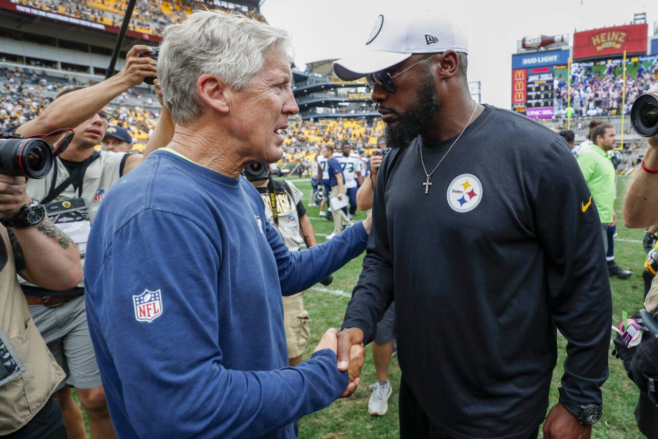 Seattle Seahawks head coach Pete Carroll, left, and Pittsburgh Steelers head coach Mike Tomlin shake hands on the field after a game Sept. 15, 2019, in Pittsburgh. (AP Photo/Don Wright)