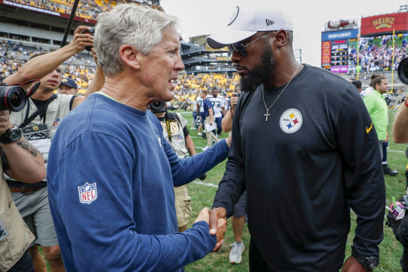Seattle Seahawks head coach Pete Carroll, left, and Pittsburgh Steelers head coach Mike Tomlin shake hands on the field after an NFL football game, Sunday, Sept. 15, 2019, in Pittsburgh. The Seahawks defeated the Steelers 28-26. (AP Photo/Don Wright)