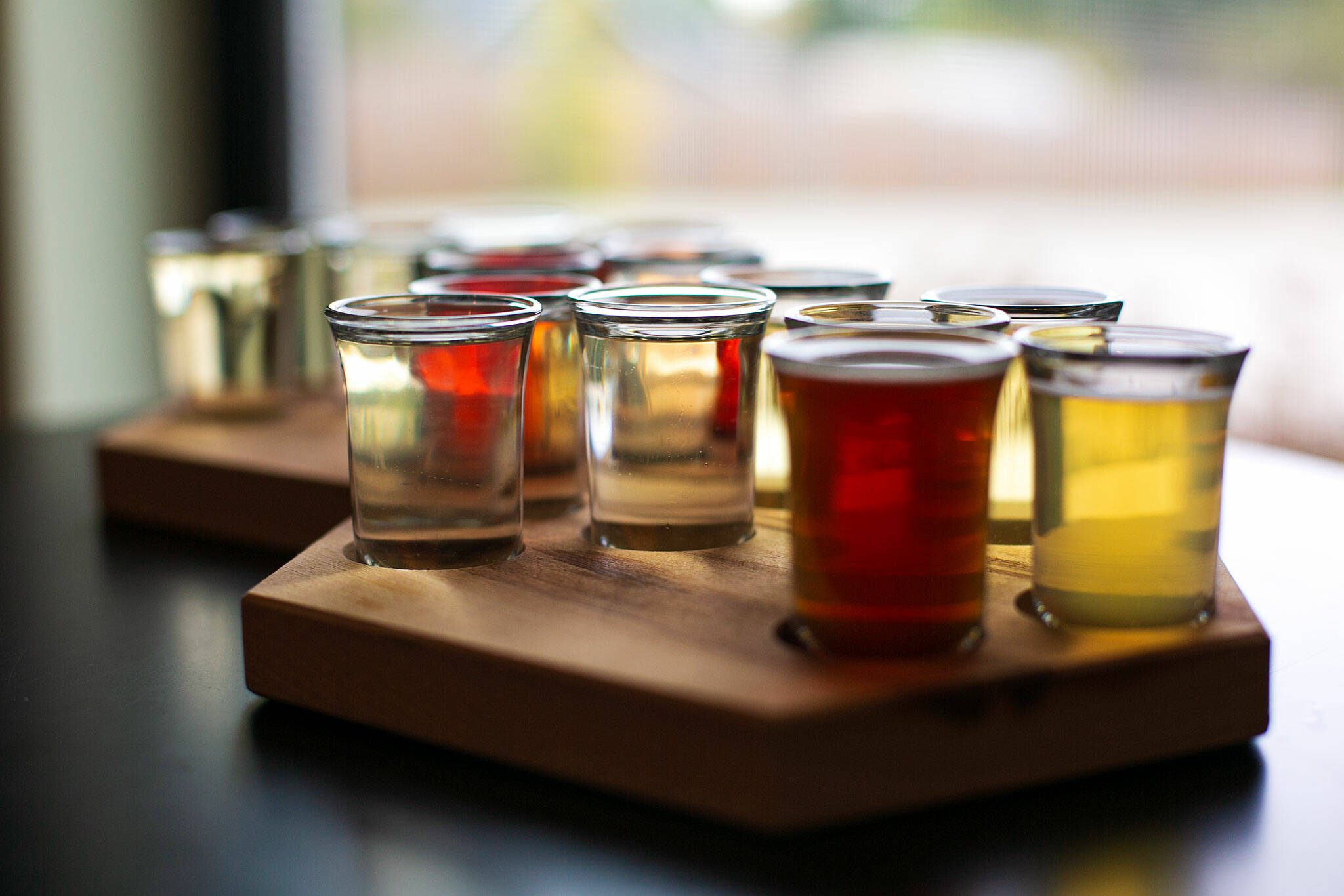 Two flights featuring a variety of flavors and strengths of mead are served at Hierophant Meadery on Wednesday, Oct. 4, 2023, in Freeland, Washington. Co-owner Jeremy Kyncl half-joked that he hopes to win a gold medal for every single variety the meadery creates. (Ryan Berry / The Herald)