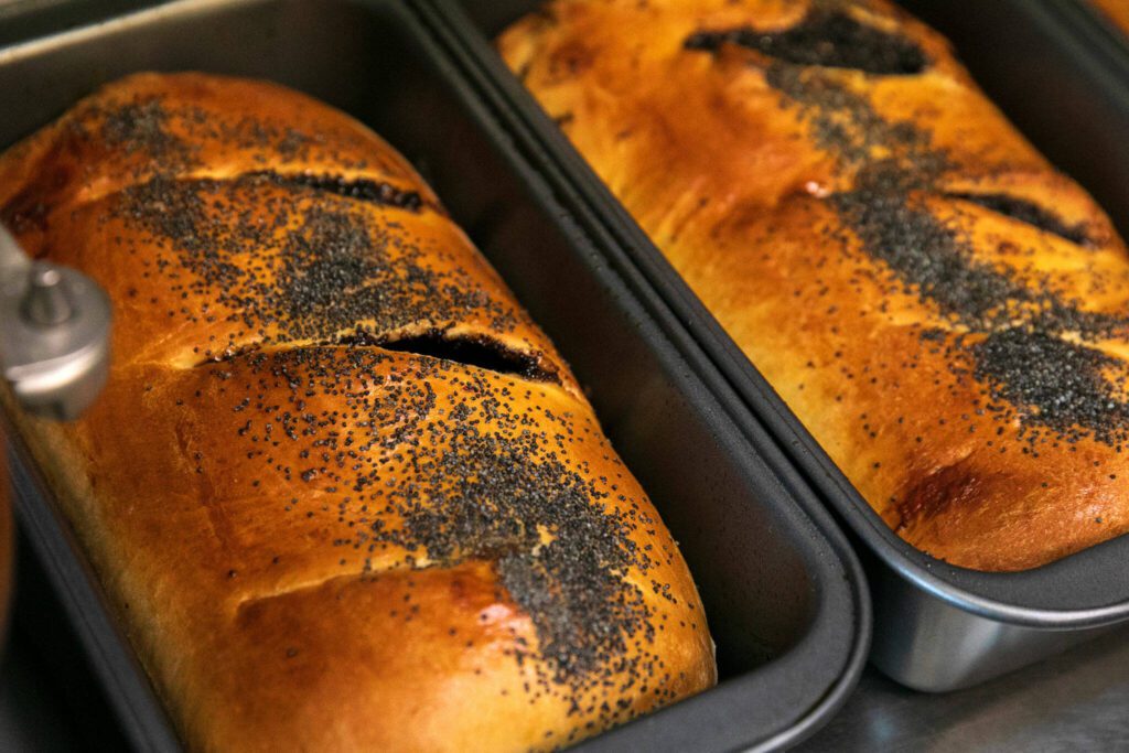 Poppy seed roll loaves rest after being taken out of the oven at European Deli Svitlana. (Ryan Berry / The Herald)

