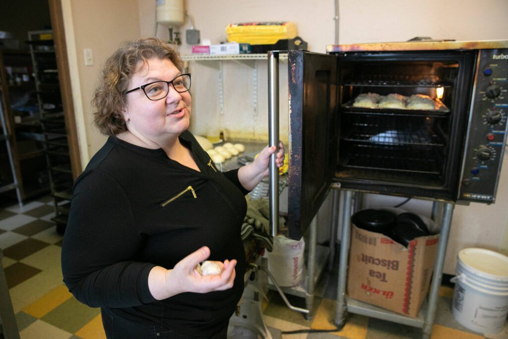Olga Gershaft, who owns European Deli Svitlana with her family, walks through the bakery in the back of the restaurant. (Ryan Berry / The Herald)
