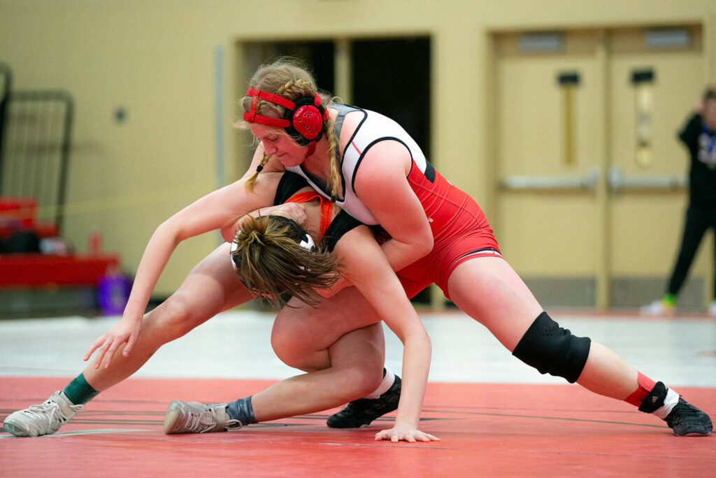 Snohomish’s Jillian Hradec tries to keep down Bellingham’s Frances Porteous during the the regional tournament on Feb. 11, 2023, at Snohomish High School in Snohomish. (Ryan Berry / The Herald)
