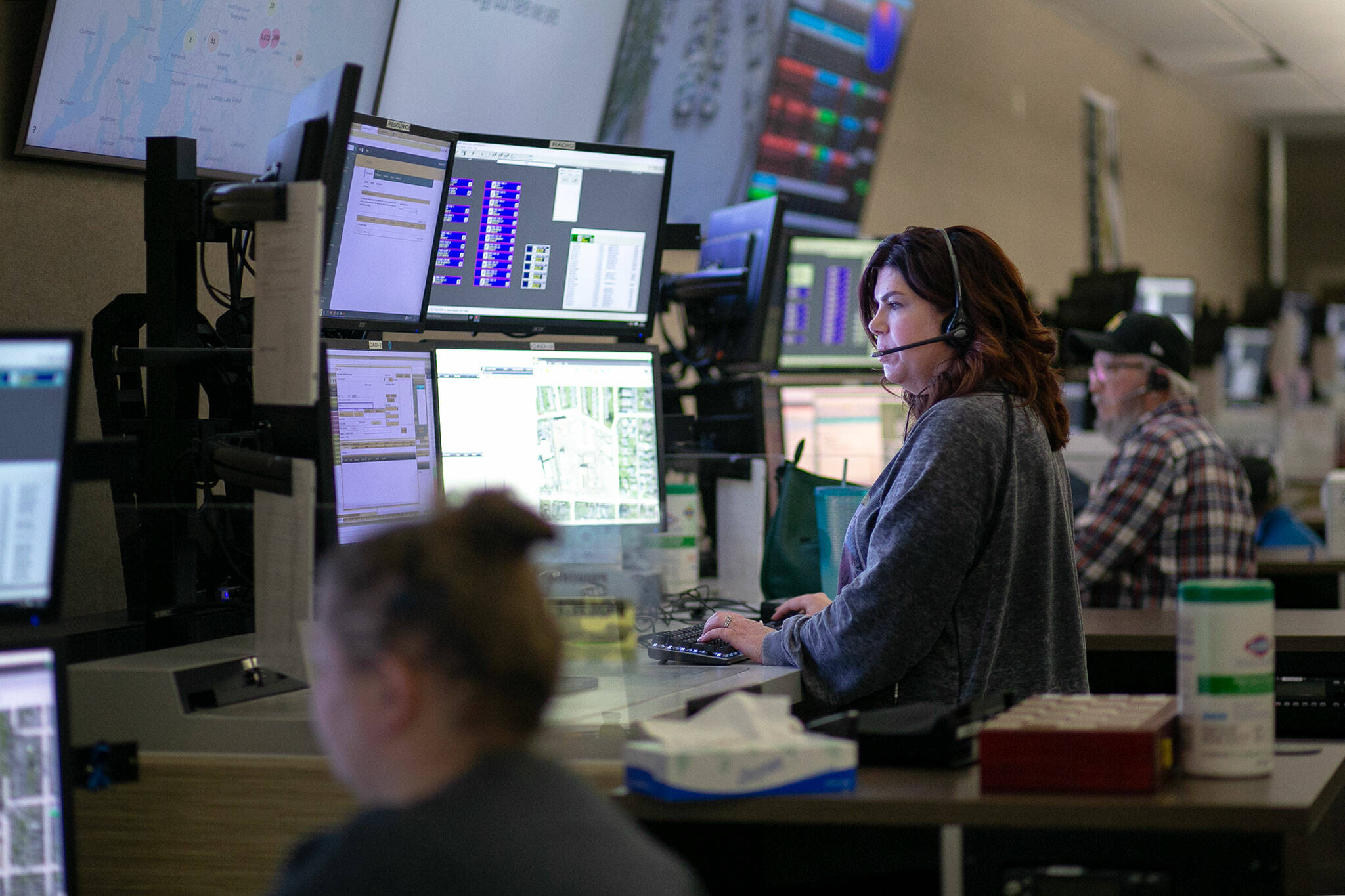 911 Dispatcher Kelly Contreras speaks with a caller while working at the Snohomish County 911 dispatch center Thursday, Jan. 18, 2024, in Everett, Washington. (Ryan Berry / The Herald)