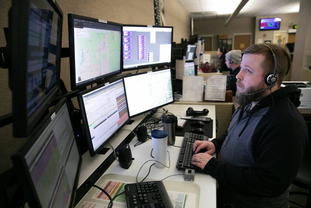 Patrick Hunstiger, a dispatcher of almost 9 years, takes a call at the Snohomish County 911 dispatch center Thursday, Jan. 18, 2024, in Everett, Washington. (Ryan Berry / The Herald)

