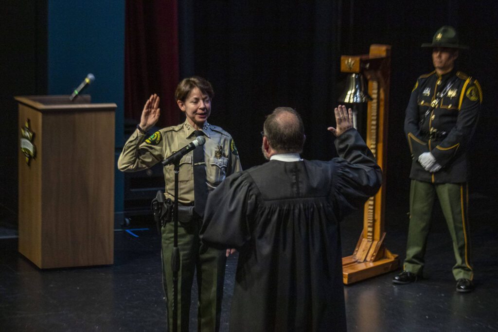 Snohomish County sheriff Susanna Johnson is sworn in by Judge Moriarty during the ceremonial oath of office at the PUD auditorium in Everett, Washington on Tuesday, Jan. 2, 2024. (Annie Barker / The Herald)
