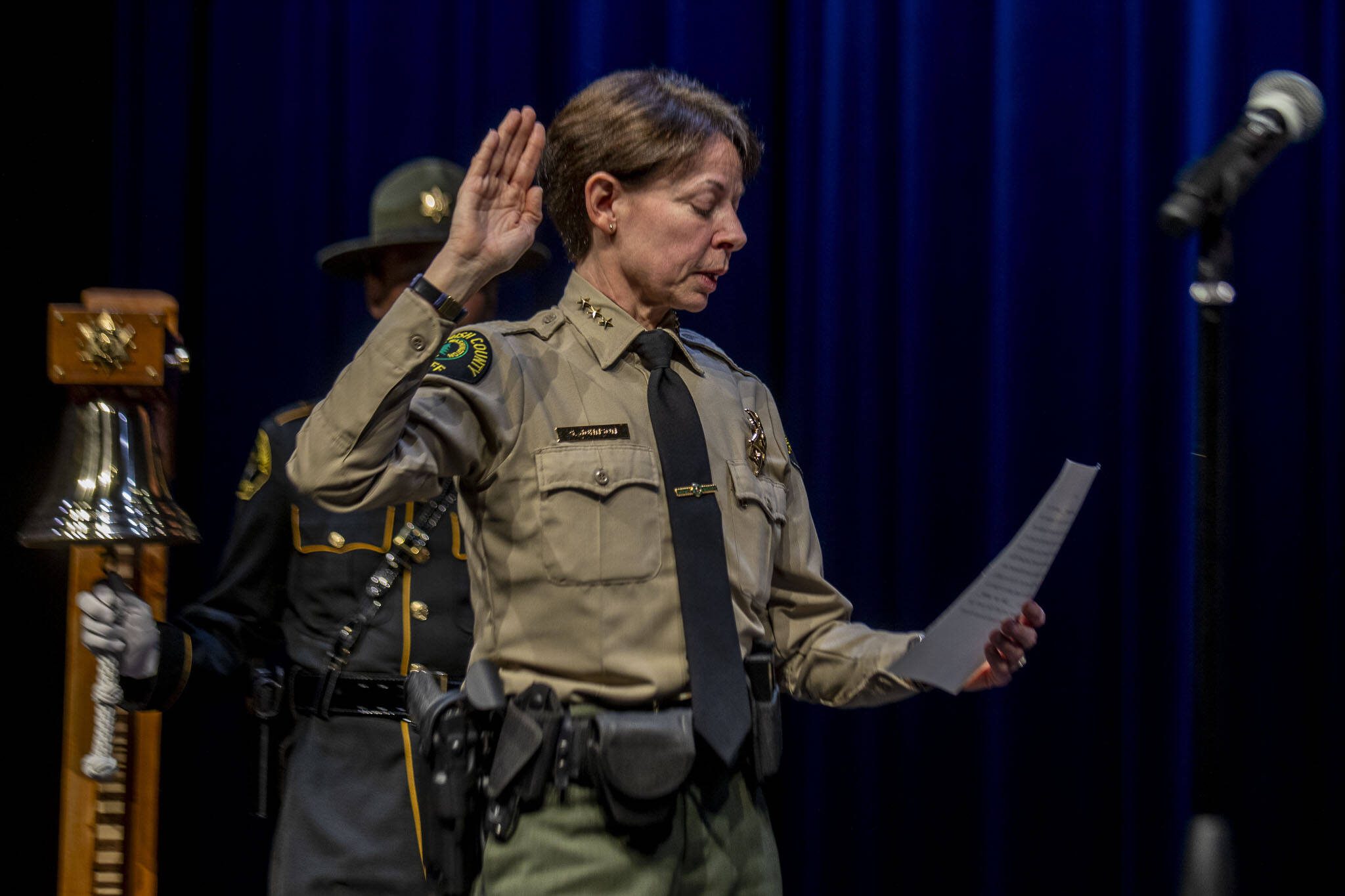 Snohomish County sheriff Susanna Johnson swears in colleagues during the ceremonial oath of office at the PUD auditorium in Everett, Washington on Tuesday, Jan. 2, 2024. (Annie Barker / The Herald)