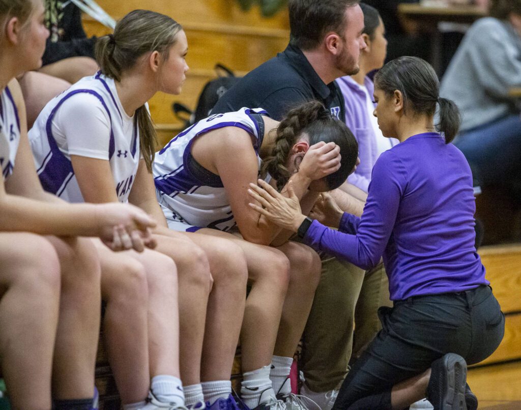 Kamiak’s Finley Gonzales is comforted by her coach during the game against Lake Stevens on Wednesday, Jan. 3, 2024 in Mukilteo, Washington. (Olivia Vanni / The Herald)
