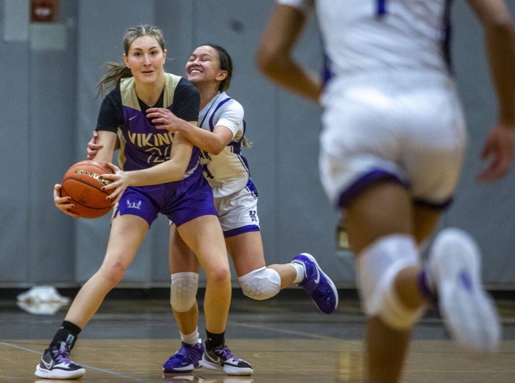 Kamaik’s Bella Hasan fouls Lake Stevens’ Kamryn Wenz in the final seconds of the game on Wednesday, Jan. 3, 2024 in Mukilteo, Washington. (Olivia Vanni / The Herald)
