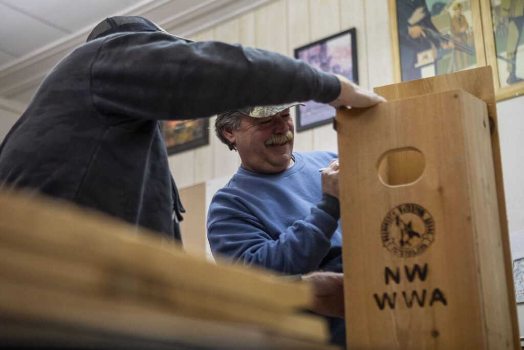Rick Billieu marks a measurement with fellow members of the Washington Waterfowl Association as they make duck boxes during a meeting at the Twin Cities Sportsmen’s Club in Stanwood, Washington on Wednesday, Jan. 10, 2024. (Annie Barker / The Herald)

