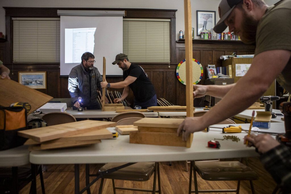 Tom Elliott, left, and Ken Smith, right, build duck boxes along with other members of the Washington Waterfowl Association during a meeting at the Twin Cities Sportsmen’s Club in Stanwood, Washington on Wednesday, Jan. 10, 2024. (Annie Barker / The Herald)
