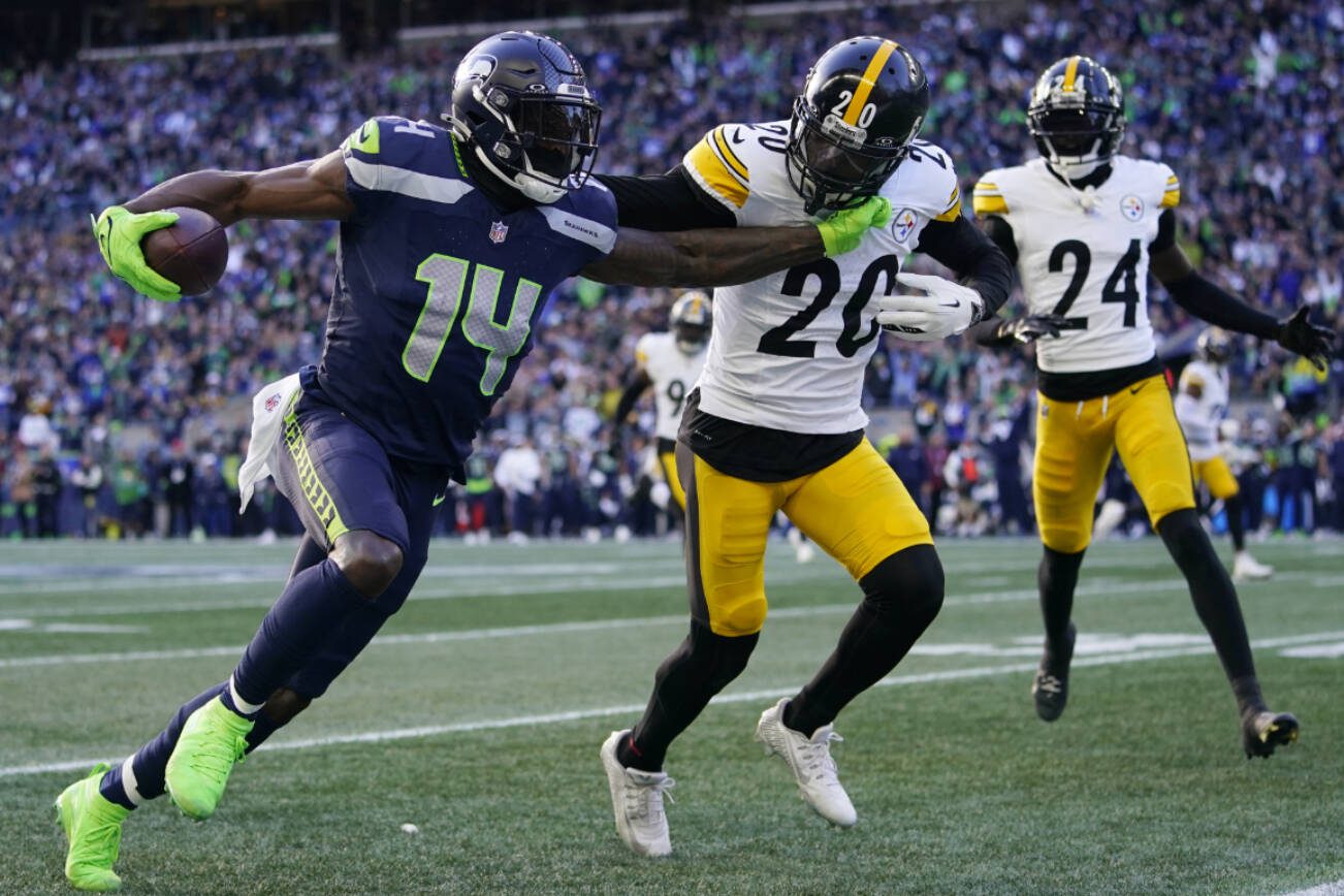 Seattle Seahawks wide receiver DK Metcalf (14) gets past Pittsburgh Steelers cornerback Patrick Peterson (20) in the first half of an NFL football game Sunday, Dec. 31, 2023, in Seattle. (AP Photo/Lindsey Wasson)