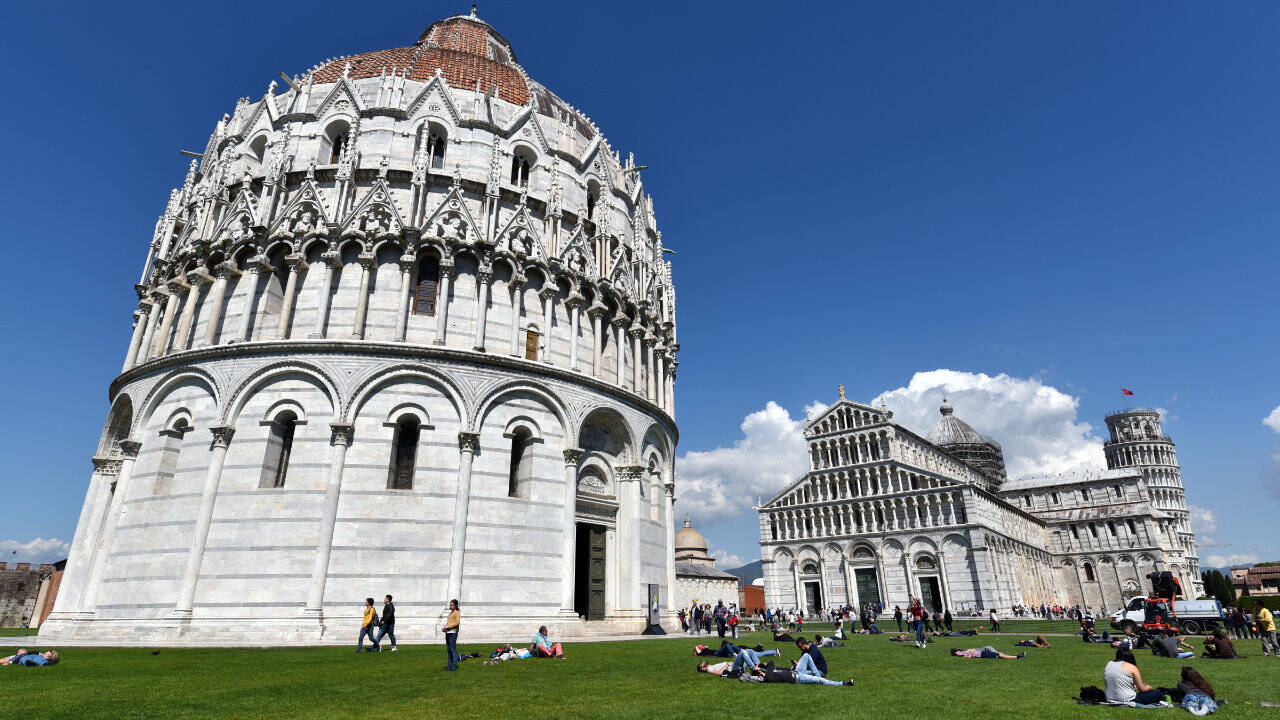 On the Field of Miracles, Pisa’s Baptistery is Italy’s biggest, with interior ambience, a hexagonal pulpit, and impressive acoustics. (Cameron Hewitt / Rick Steves’ Europe)