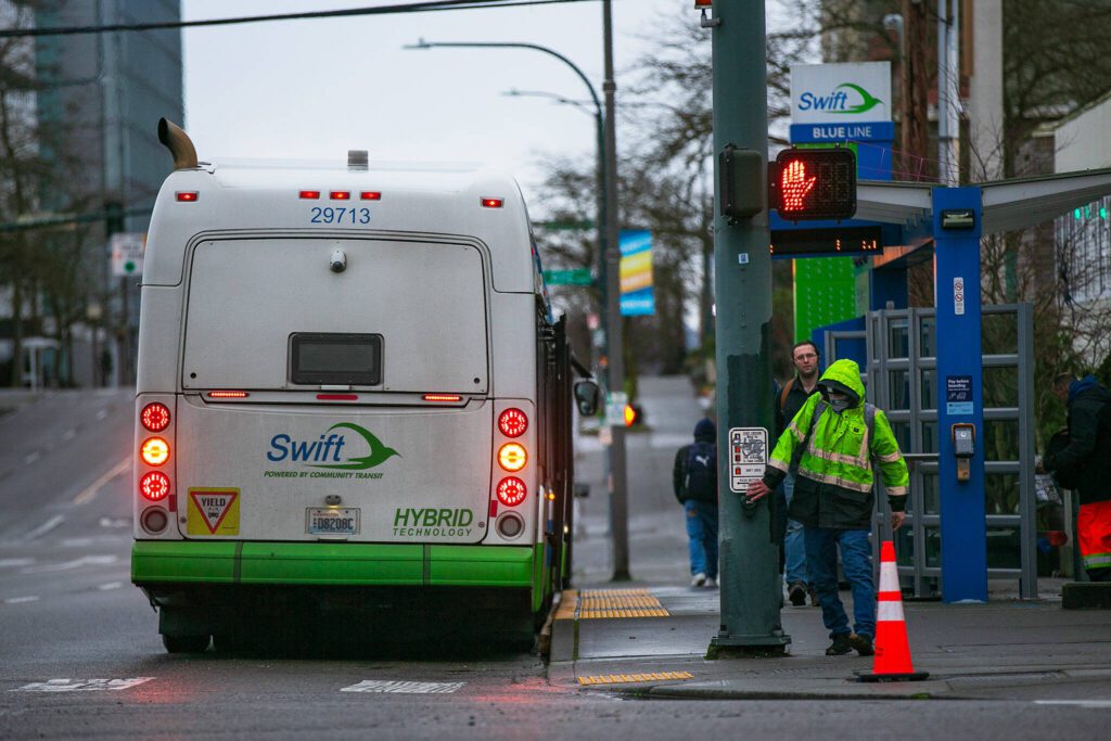 Riders get off the Swift Blue Line northbound bus on Pacific Avenue on Thursday, Jan. 11, 2024, in downtown Everett, Washington. (Ryan Berry / The Herald)
