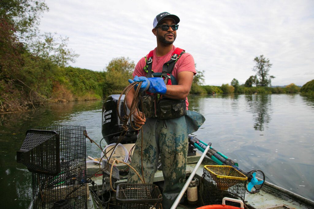 Ithamar Glumac, a native of Texas who is one of only a few commercial crawfishermen in Washington State, spools rope while collecting his traps from the Snohomish River on Tuesday, Sept. 19, 2023, near Snohomish, Washington. Glumac is a welding engineer by day but has also run Washington Crawfish Company since 2015. (Ryan Berry / The Herald)
