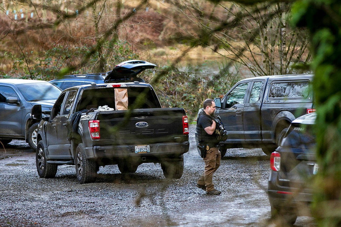 A large number off law enforcement are gathered at a Skykomish River water access on Ben Howard Road on Wednesday, Jan. 3, 2024, in Monroe, Washington. (Ryan Berry / The Herald)