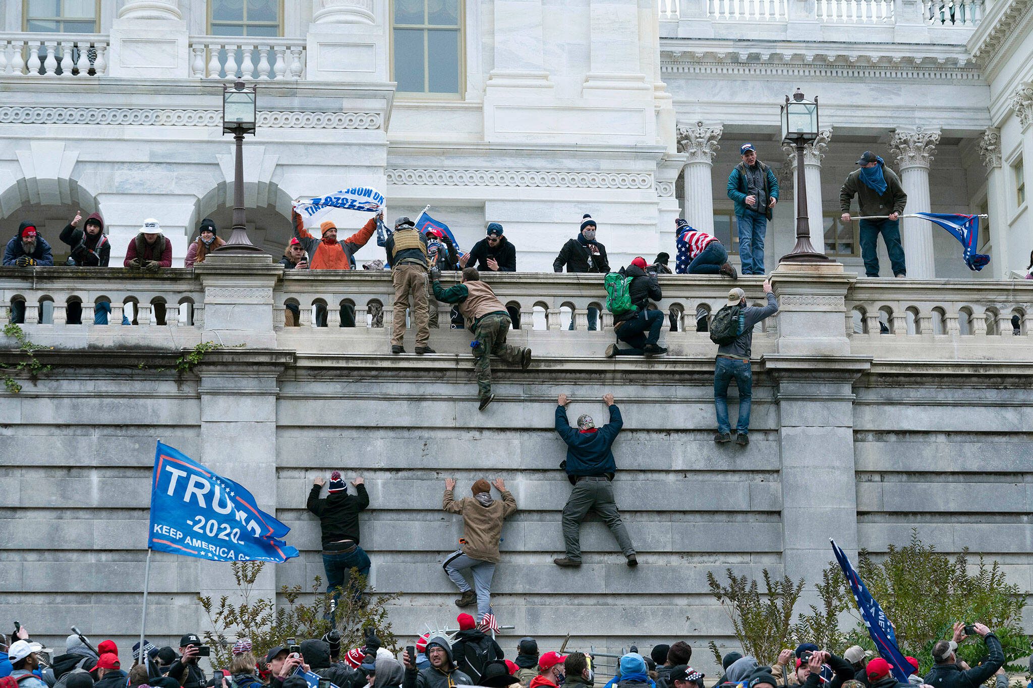 Violent insurrectionists loyal to President Donald Trump scale the west wall of the the U.S. Capitol in Washington, D.C on Jan. 6, 2021. (AP Photo/Jose Luis Magana, File)
