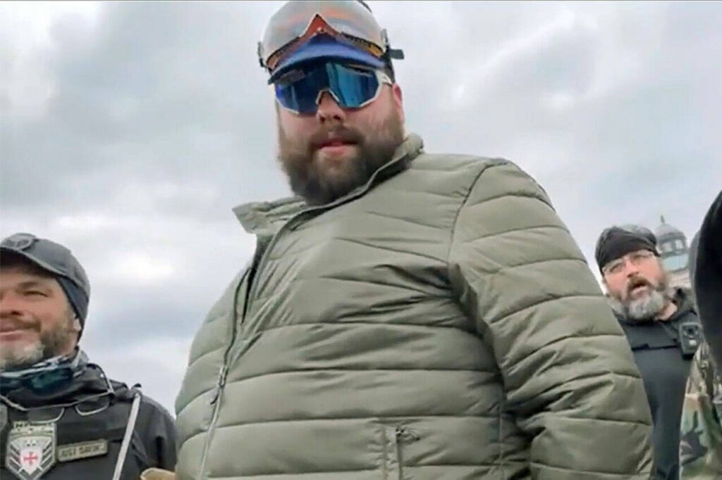 Daniel Scott (center, in green jacket) is shown in a video before the Proud Boys and other rioters stormed the U.S. Capitol building on Jan. 6, 2021, in Washington, D.C. (U.S. Attorney’s Office for the District of Columbia)
