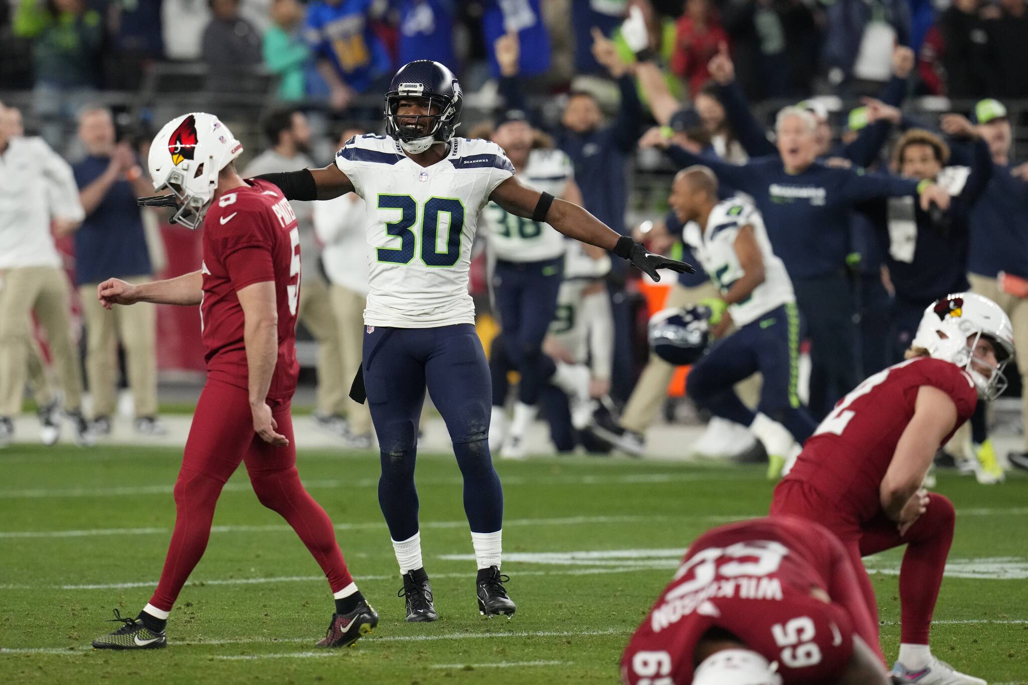Seattle Seahawks cornerback Michael Jackson (30) celebrates as Arizona Cardinals place kicker Matt Prater (5) walks off the field after missing a 51-yard field-goal attempt as time runs out in the fourth quarter of Sunday’s game in Glendale, Ariz. The Seahawks won 21-20. (AP Photo/Ross D. Franklin)