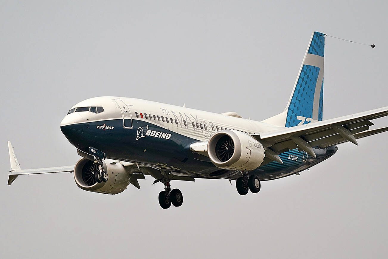 FILE - In this Wednesday, Sept. 30, 2020, file photo, a Boeing 737 Max jet, piloted by Federal Aviation Administration Chief Steve Dickson, prepares to land at Boeing Field following a test flight in Seattle. The FAA is poised to clear the Boeing 737 Max to fly again after grounding the jets for nearly two years due to a pair of disastrous crashes that killed 346 people. (AP Photo/Elaine Thompson, File)