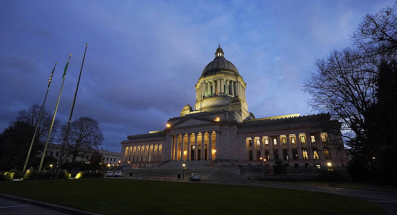 The Legislative Building is seen at dusk Feb. 15, 2022, following a session of the Legislature in Olympia. (Ted S. Warren / Associated Press)