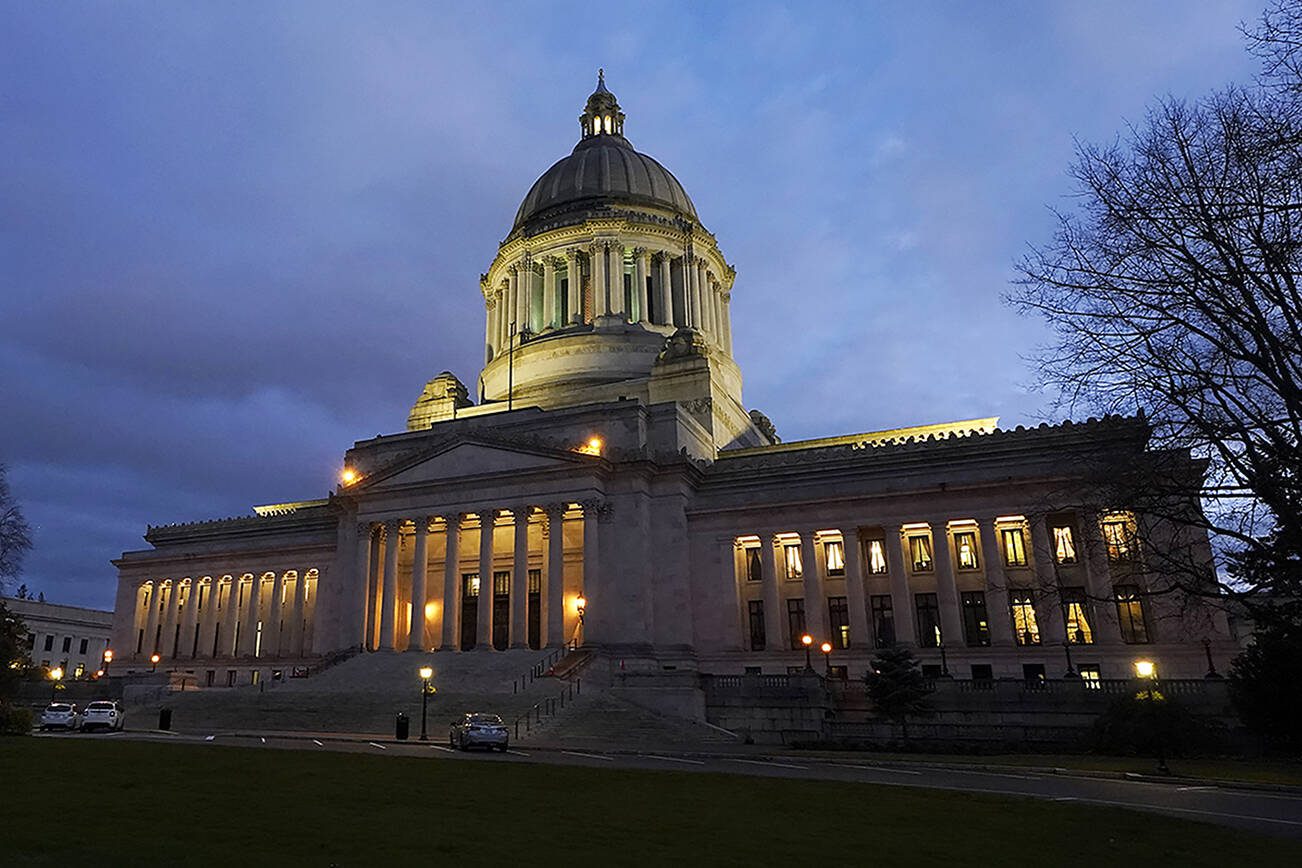 The Legislative Building is seen at dusk Tuesday, Feb. 15, 2022, following a session of the Legislature in Olympia, Wash. (AP Photo/Ted S. Warren)