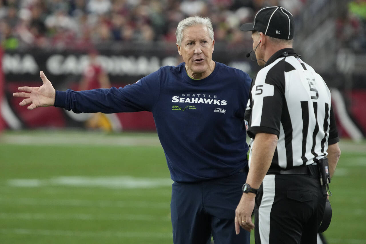 Seattle Seahawks head coach Pete Carroll argues a call with side judge Jim Quirk during Sunday’s game against the Arizona Cardinals in Glendale, Ariz. (AP Photo/Rick Scuteri)