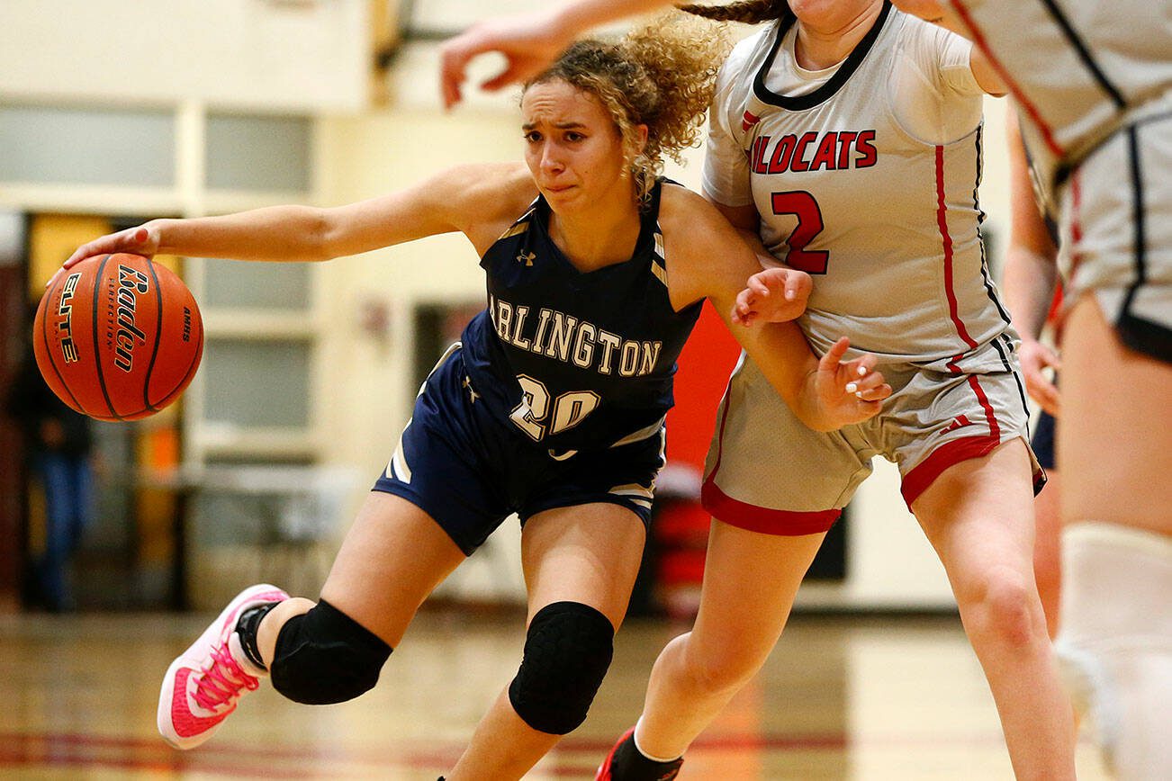 Arlington senior Samara Morrow drives on a defender against Archbishop Murphy on Tuesday, Jan. 9, 2024, at Archbishop Murphy High School in Everett, Washington. (Ryan Berry / The Herald)