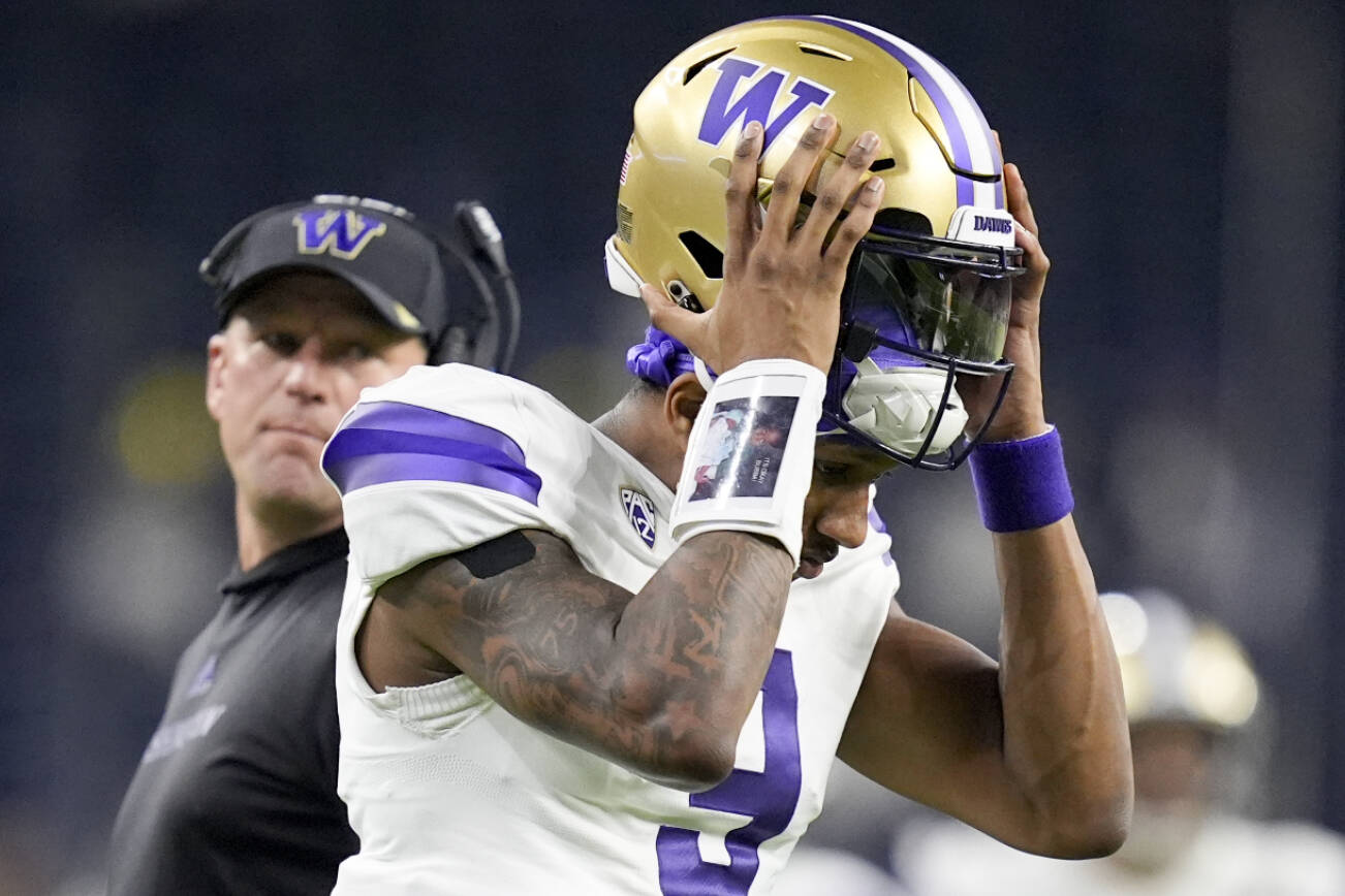 Washington quarterback Michael Penix Jr. leaves field at the end of the half against Michigan of the national championship NCAA College Football Playoff game Monday, Jan. 8, 2024, in Houston. (AP Photo/Eric Gay)