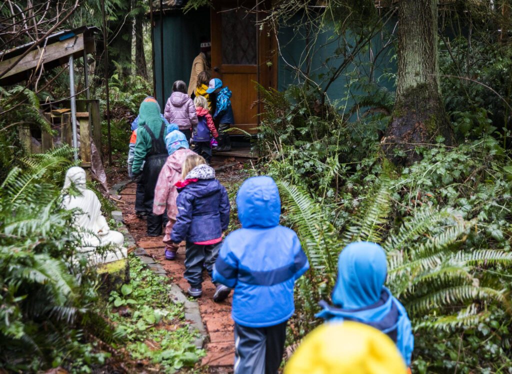 Springwood Forest School students make their way into a yurt for a snack and a story on Monday, Jan. 22, 2024 in Camano Island, Washington. (Olivia Vanni / The Herald)
