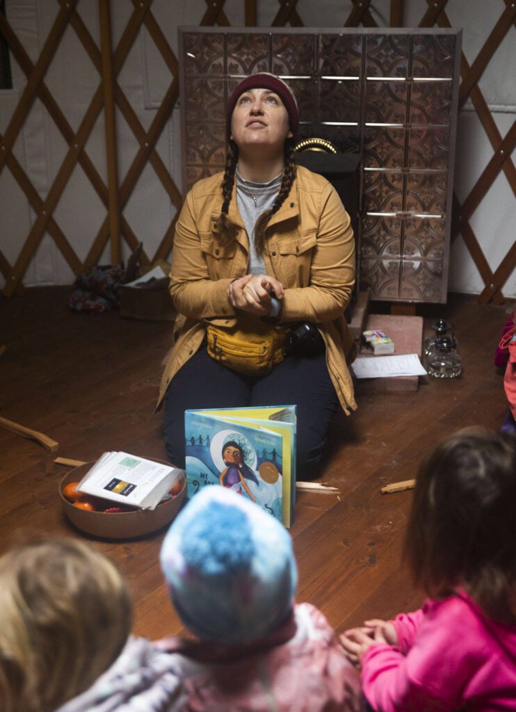 Heather White talks to the students about using their senses to describe the rain hitting the skylight of the yurt on Monday, Jan. 22, 2024 in Camano Island, Washington. (Olivia Vanni / The Herald)

