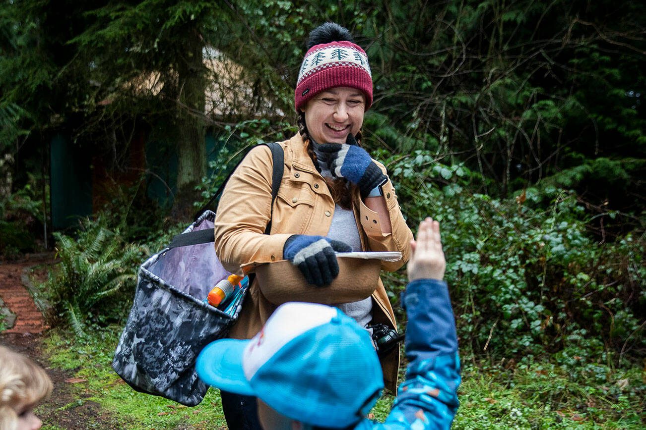 Heather White smiles while students raise their hands to answer a question on Monday, Jan. 22, 2024 in Camano Island, Washington. (Olivia Vanni / The Herald)