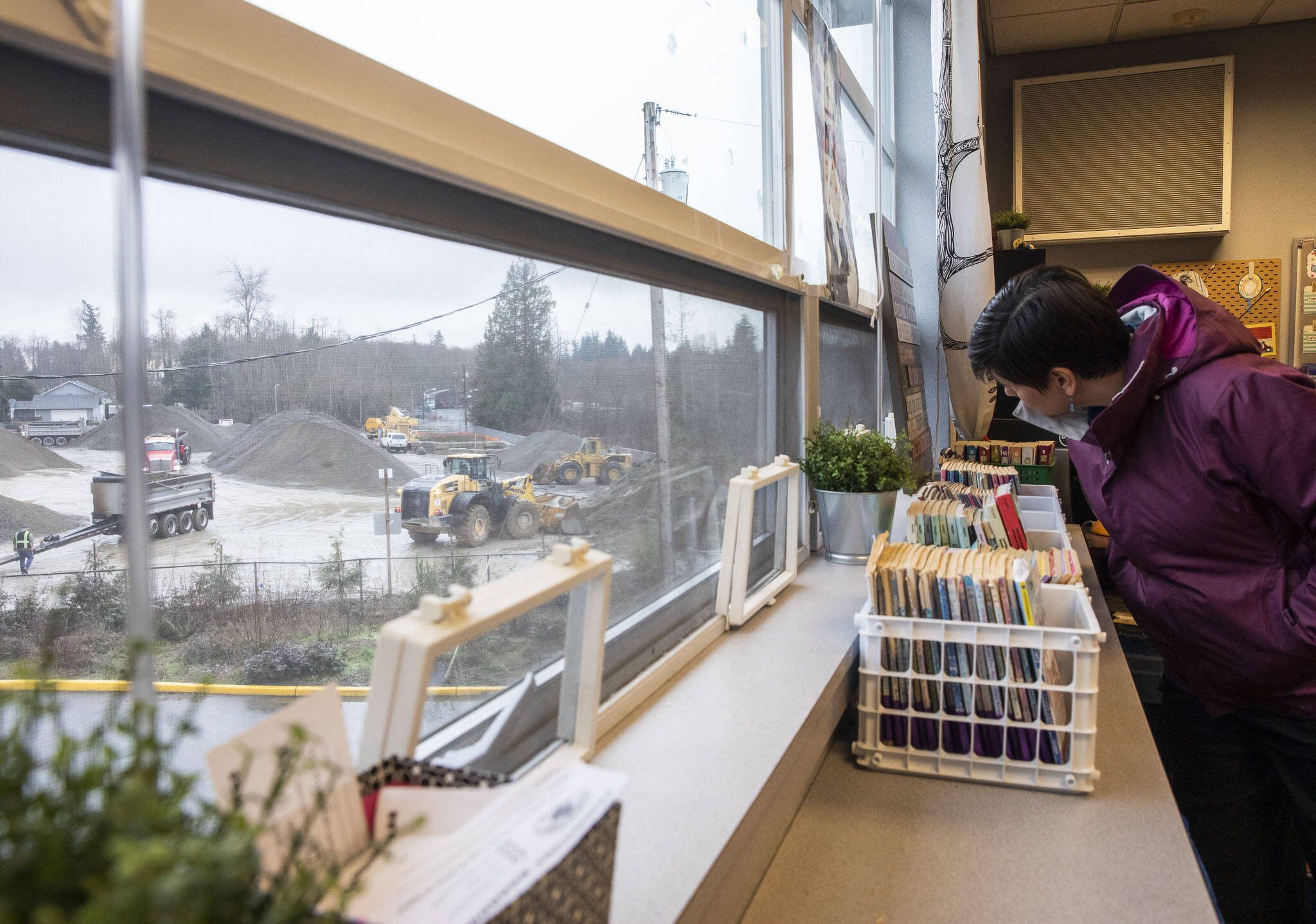 Mukilteo School District Communications Director Diane Bradford looks out the window of a second floor classroom at Fairmount Elementary that looks out onto Mountain Loop Mine on Wednesday, Jan. 10, 2024 in Everett, Washington. (Olivia Vanni / The Herald)