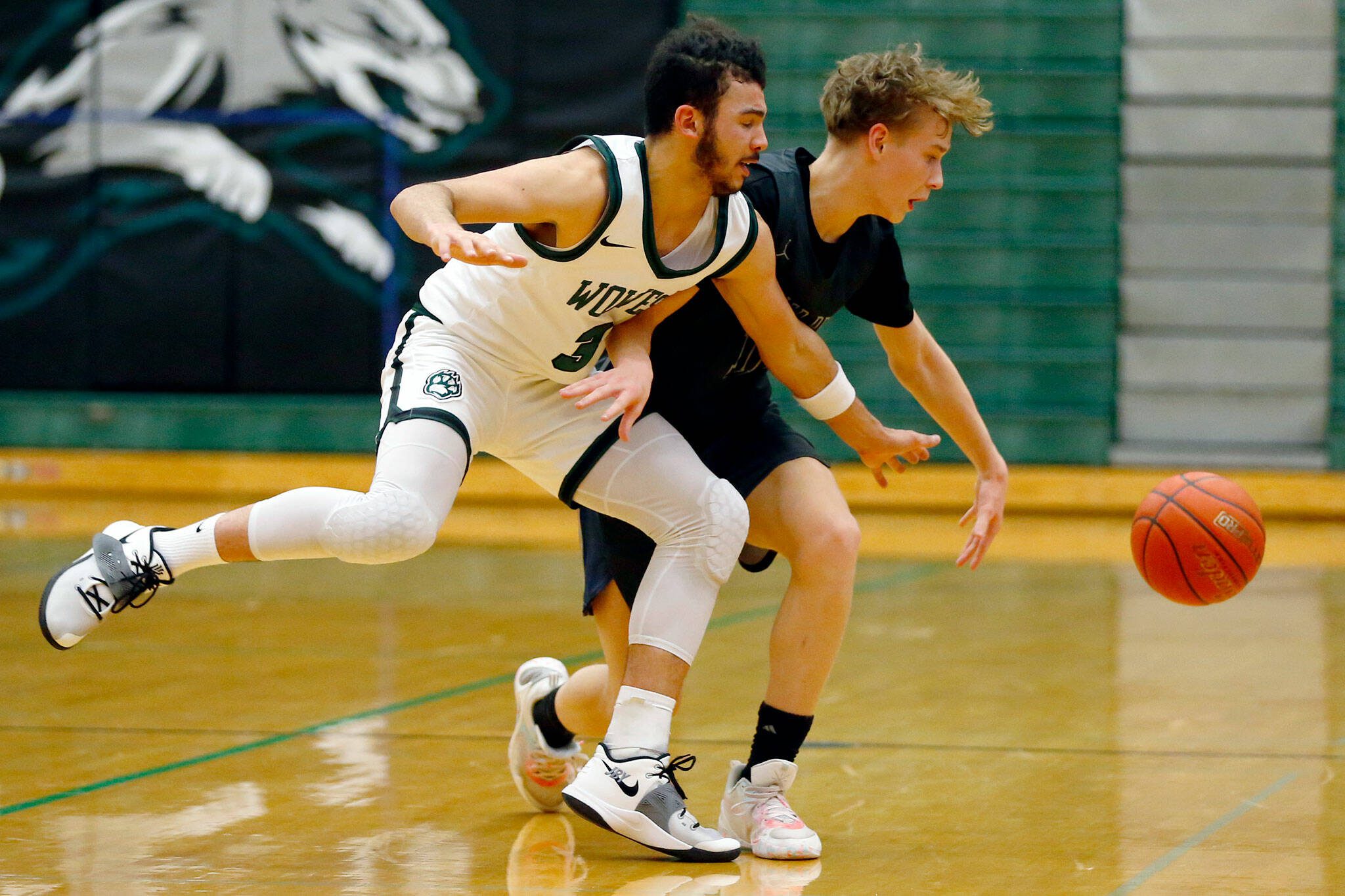 Jackson’s Trey Hawkins knocks the ball loose against Glacier Peak on Wednesday at Henry M. Jackson High School in Mill Creek. (Ryan Berry / The Herald)