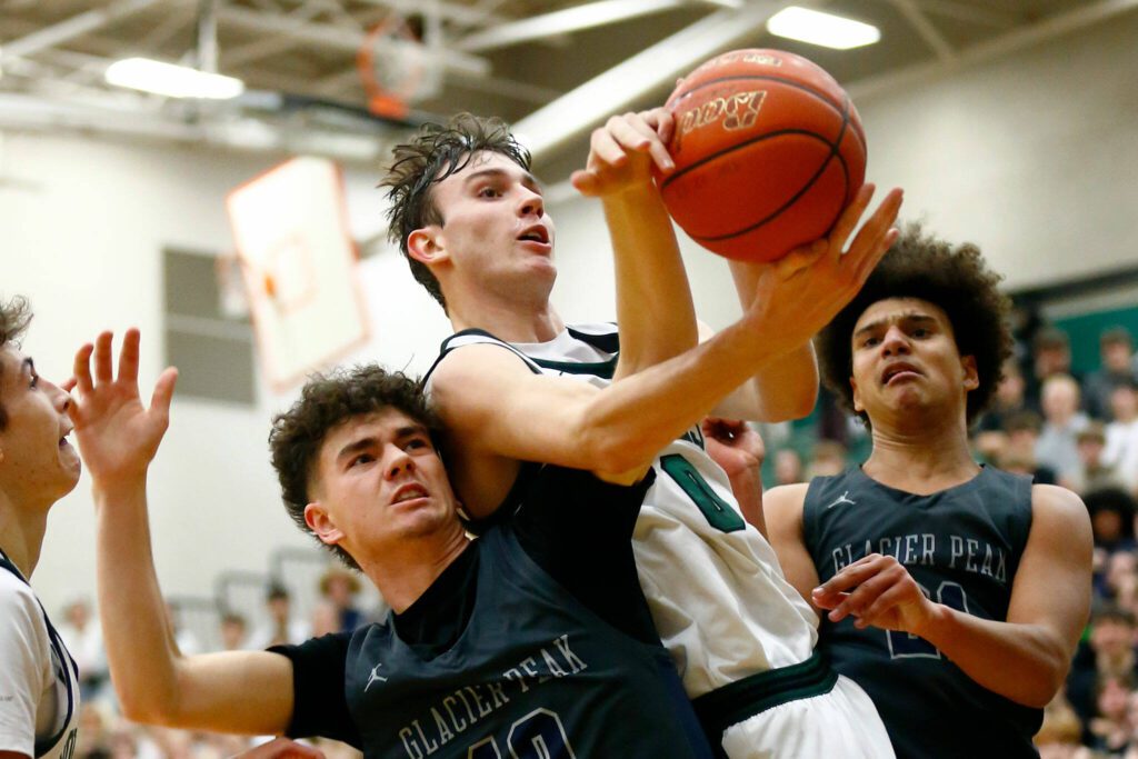 Jackson senior forward Ryan Mcferran comes away with a contested rebound against Glacier Peak on Wednesday, Jan. 10, 2024, at Henry M. Jackson High School in Mill Creek, Washington. (Ryan Berry / The Herald)

