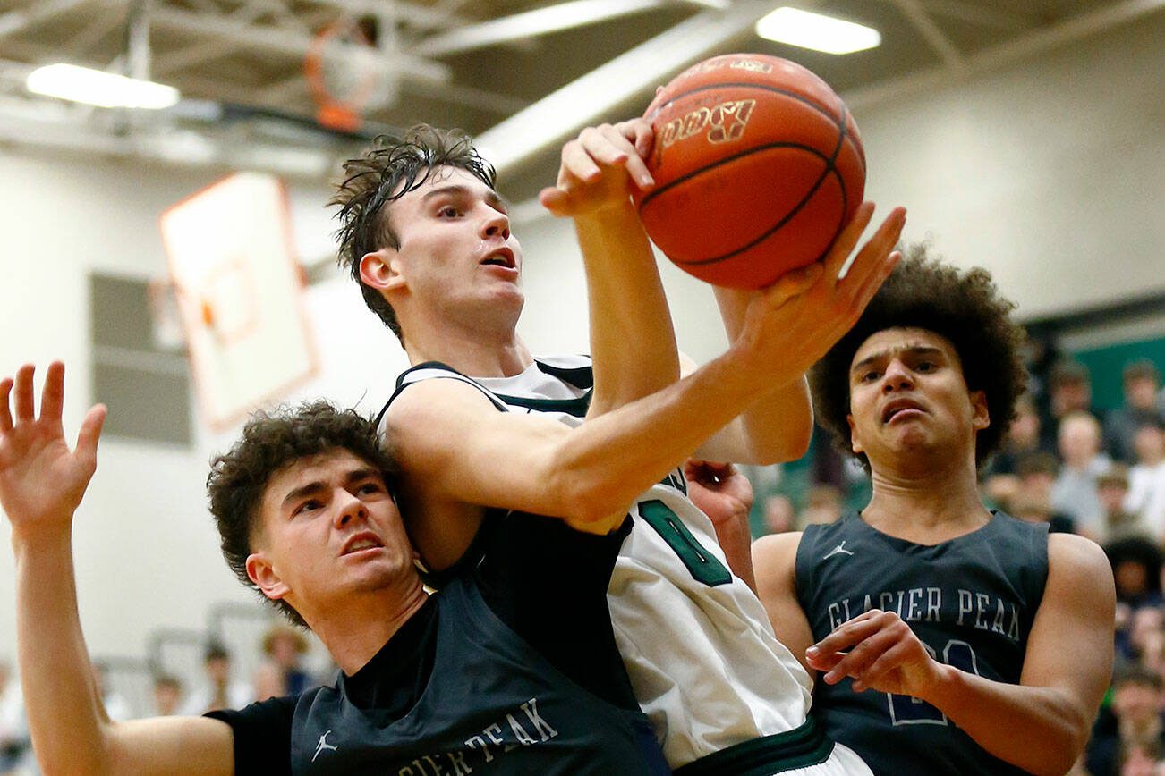 Jackson senior forward Ryan Mcferran comes away with a contested rebound against Glacier Peak on Wednesday, Jan. 10, 2024, at Henry M. Jackson High School in Mill Creek, Washington. (Ryan Berry / The Herald)