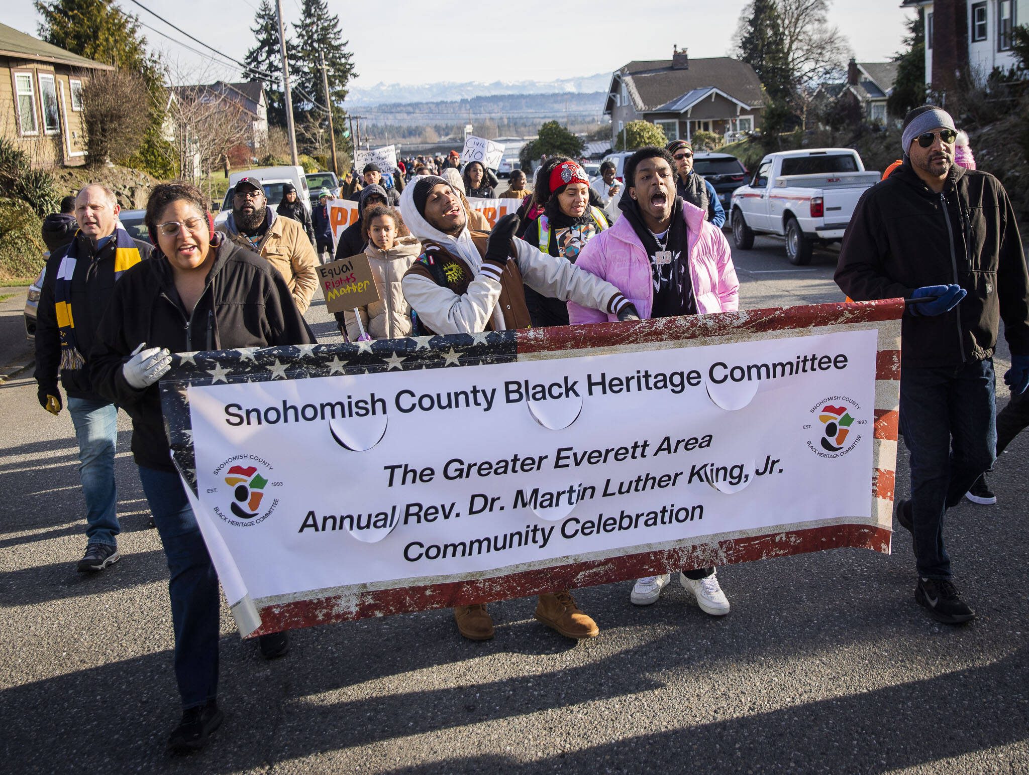 Noah Jackson, right, and Daniel “Prince” Cacho, left, sing while they lead a group of approximately 100 people Monday in a Martin Luther King Jr. Day march in Everett, Washington. (Olivia Vanni / The Herald)