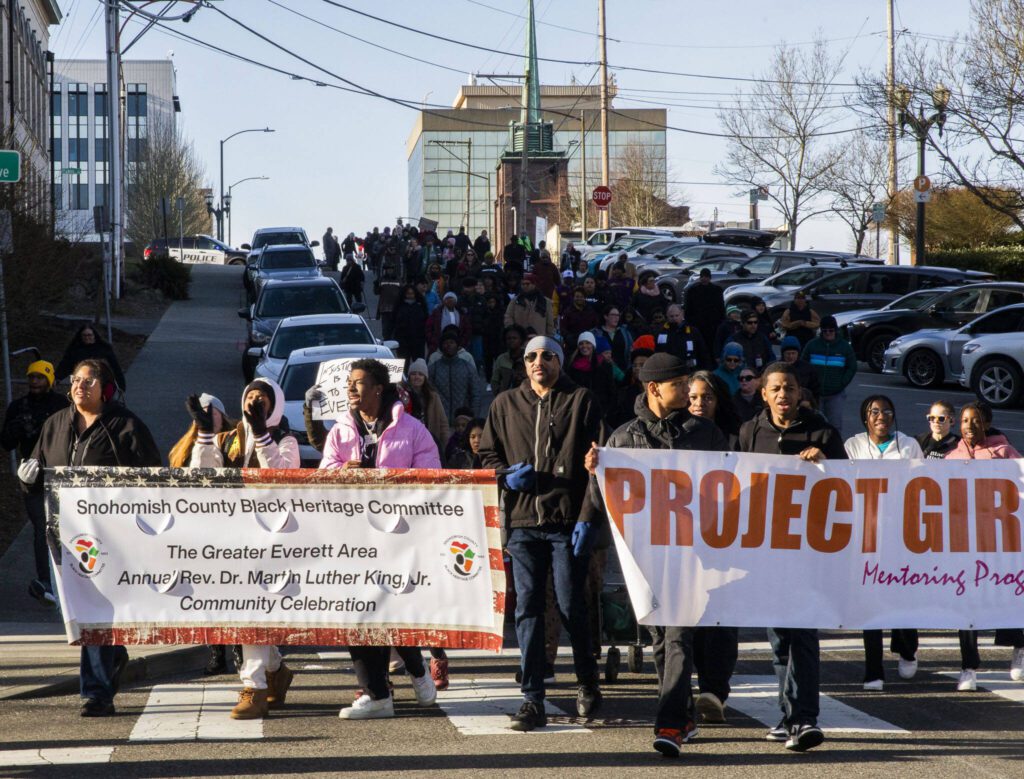 People walk down Wall Street in Everett during the Snohomish County Black Heritage Committee’s annual Martin Luther King Jr. Day march on Monday, Jan. 15, 2024 in Everett, Washington. (Olivia Vanni / The Herald)
