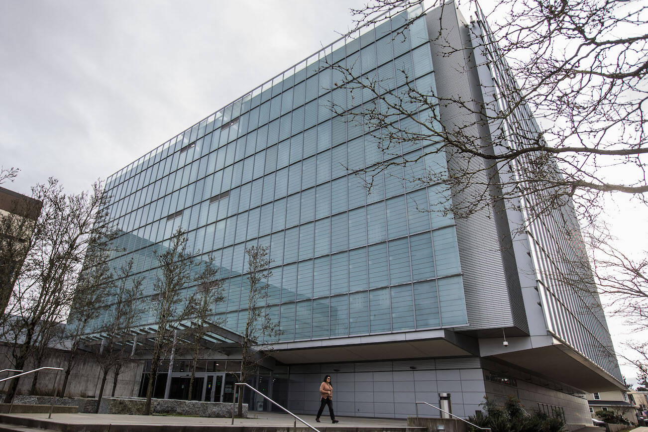 A person walks out of the Snohomish County Corrections building on Wednesday, Jan. 3, 2024 in Everett, Washington. (Olivia Vanni / The Herald)