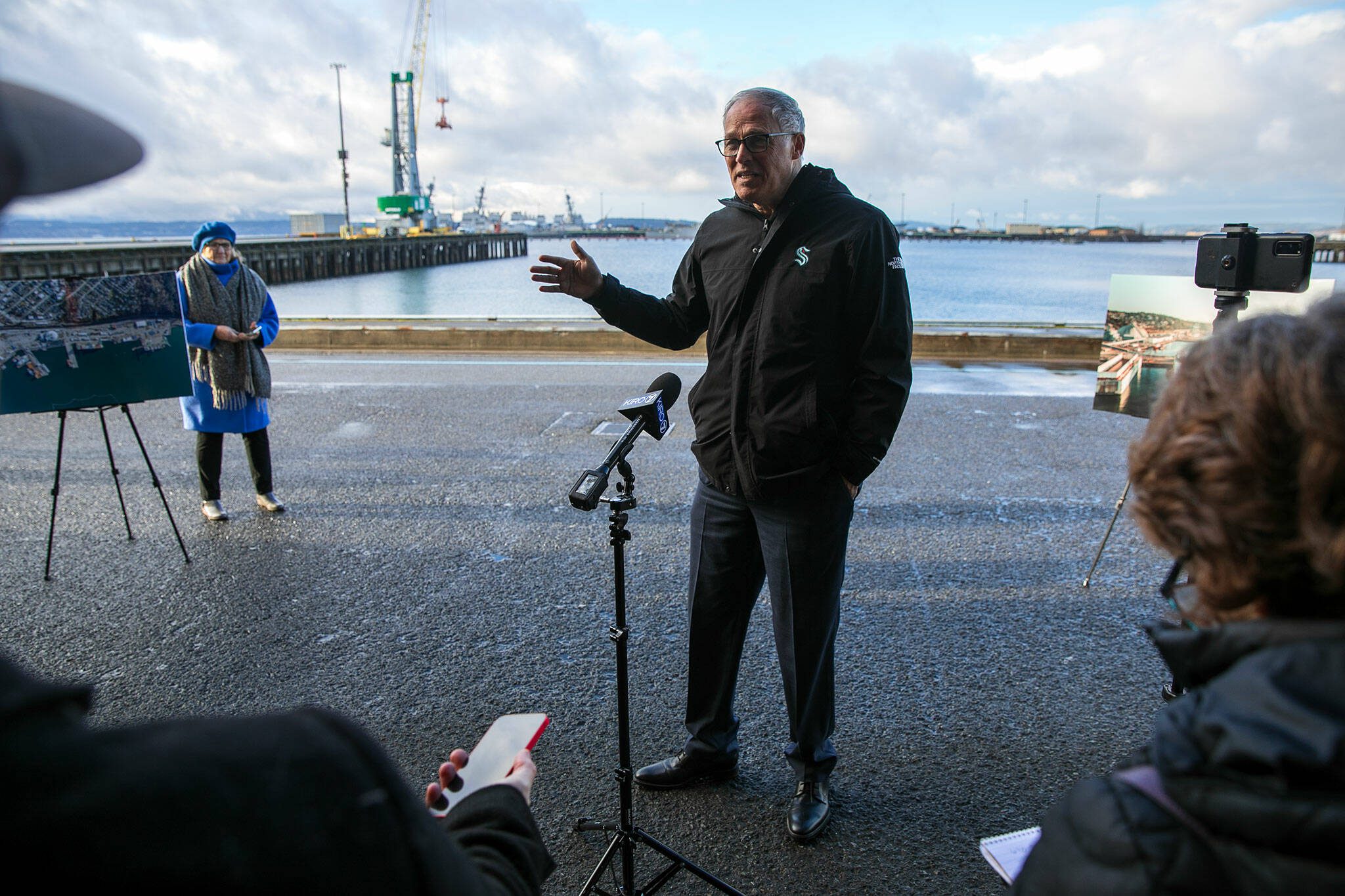 Gov. Jay Inslee briefly speaks with the media at the Port of Everett Seaport on Wednesday, Jan. 17, 2024, in Everett, Washington. Inslee was in town to meet with Port officials and discuss future improvements to a pier that would allow electric vessels to charge while moored at the Seaport.
