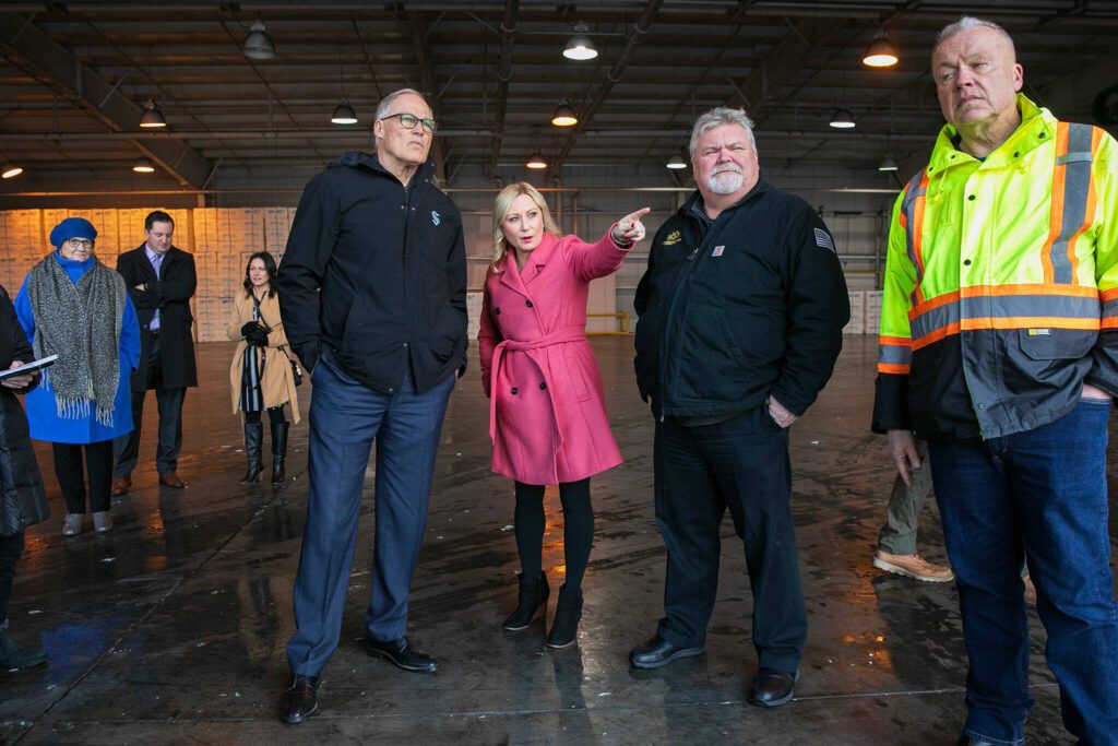 Gov. Jay Inslee, center left, meets with Port of Everett CEO Lisa Lefeber, center, and COO Carl Wollebek, center right, at the Port of Everett Seaport on Wednesday, Jan. 17, 2024, in Everett, Washington. (Ryan Berry / The Herald)
