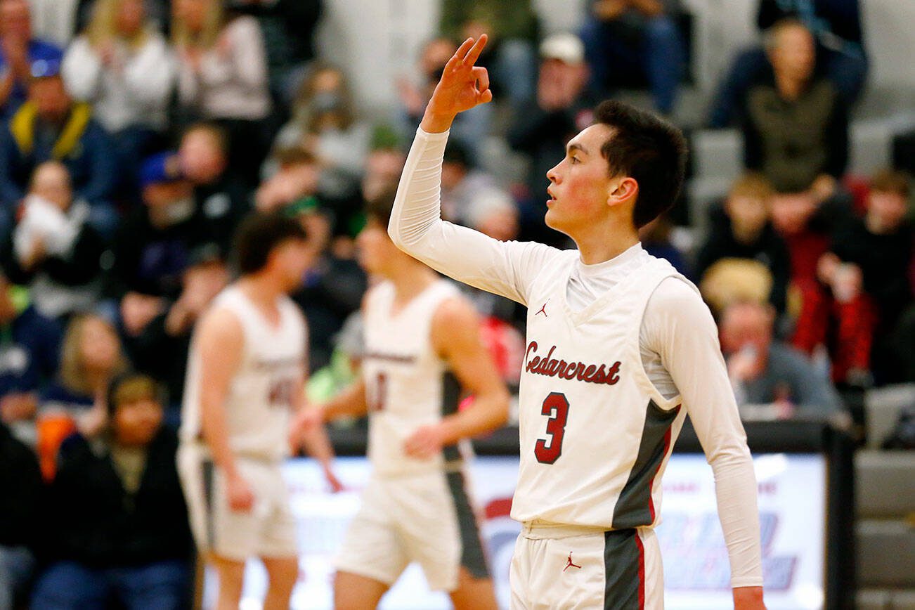 Cedarcrest’s Adam Rawlings holds up a three after recording an assist against Marysville Getchell on Tuesday, Jan. 16, 2024, at Cedarcrest High School in Duvall, Washington. (Ryan Berry / The Herald)