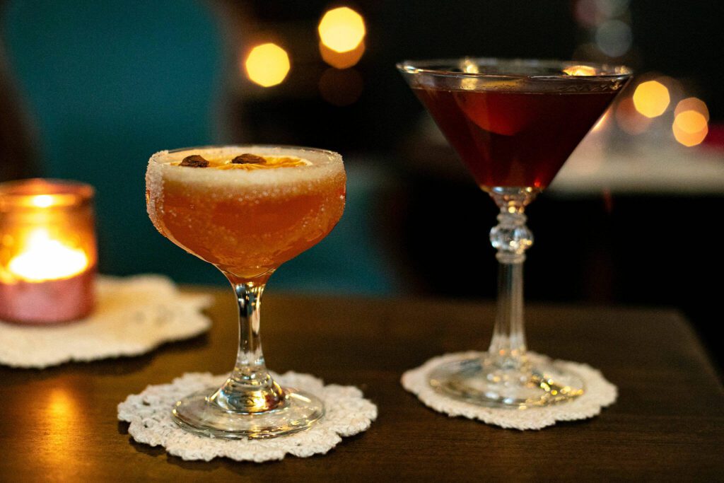 The Chai Side Car, left, and The Perfect Manhattan are served up on doilies at The Colby Club on Monday, Jan. 15, 2024, in Everett, Washington. (Ryan Berry / The Herald)
