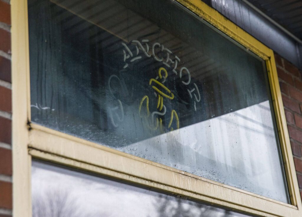 An Anchor Pub neon sign is visible in the window on Thursday, Jan. 18, 2024 in Everett, Washington. (Olivia Vanni / The Herald)
