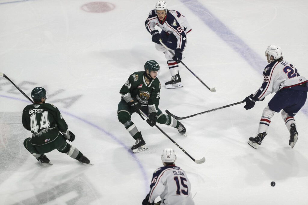 Silvertips’ Tarin Smith (24) fights for the puck during a game between the Everett Silvertips and Tri-City Americans at the Angel of the Winds Arena on Sunday, Jan. 21, 2024. The Silvertips won, 5-3. (Annie Barker / The Herald)
