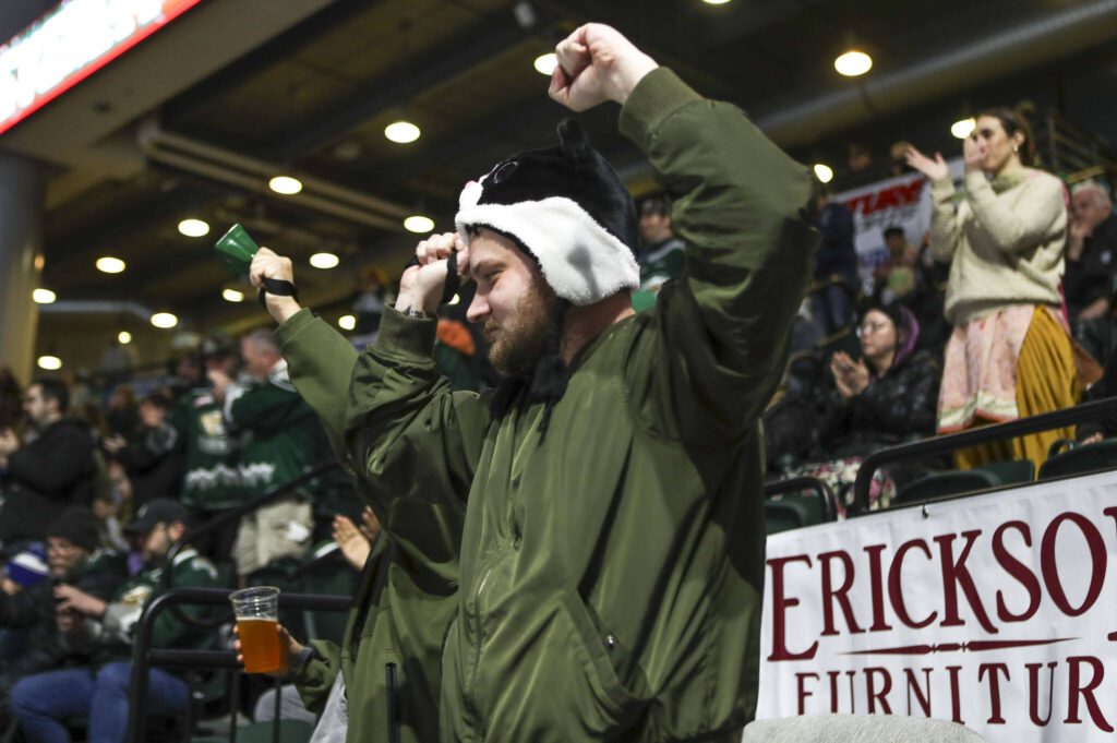 Fans celebrate a goal during a game between the Everett Silvertips and Tri-City Americans at the Angel of the Winds Arena on Sunday, Jan. 21, 2024. The Silvertips won, 5-3. (Annie Barker / The Herald)
