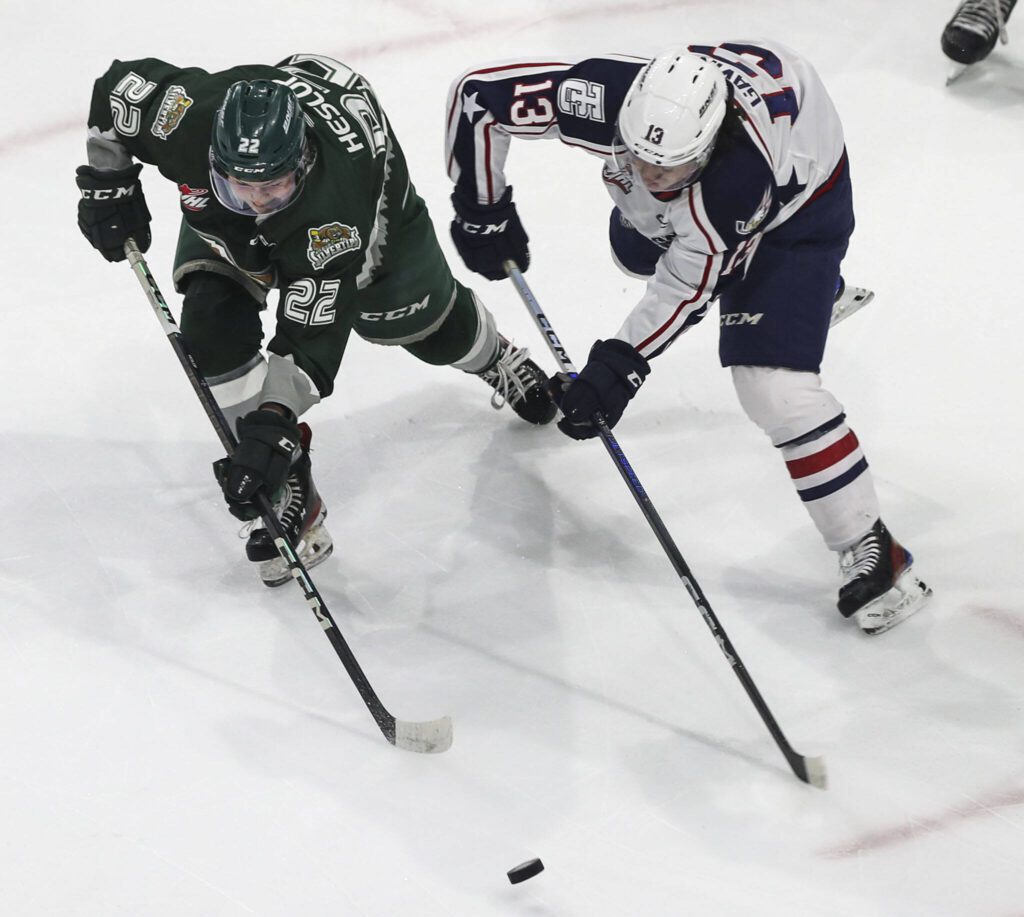 Silvertips’ Jesse Heslop (22) fights for the puck during a game between the Everett Silvertips and Tri-City Americans at the Angel of the Winds Arena on Sunday, Jan. 21, 2024. The Silvertips won, 5-3. (Annie Barker / The Herald)

