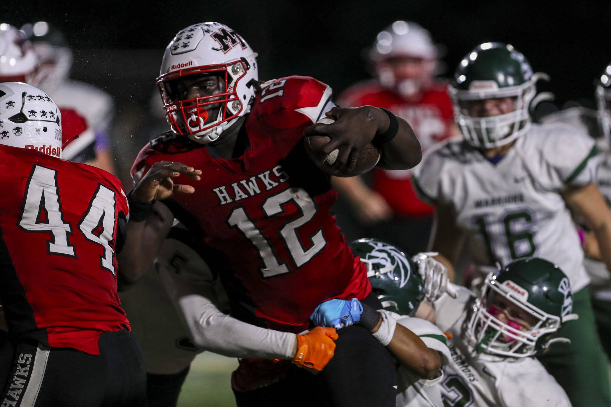 Mountlake Terrace’s Zaveon Jones (12) fights through tackles during a game against Edmonds-Woodway on Oct. 20, 2023, at Edmonds Stadium in Edmonds. (Annie Barker / The Herald)