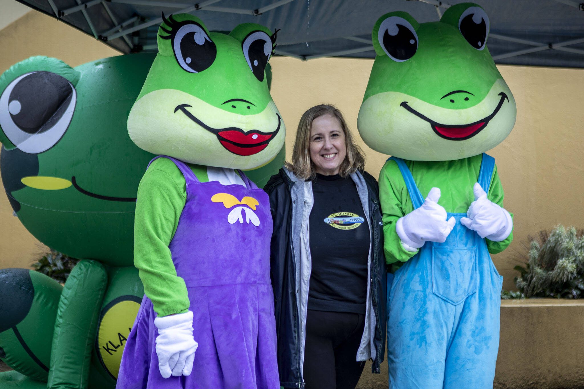 Lil, left, Snohomish Chamber of Commerce Executive Director Nancy Keith, center, and Tad, right, pose for a photo during the final annual GroundFrog Day event at the Carnegie building in Snohomish, Washington, on Saturday, Jan. 27, 2024. (Annie Barker / The Herald)