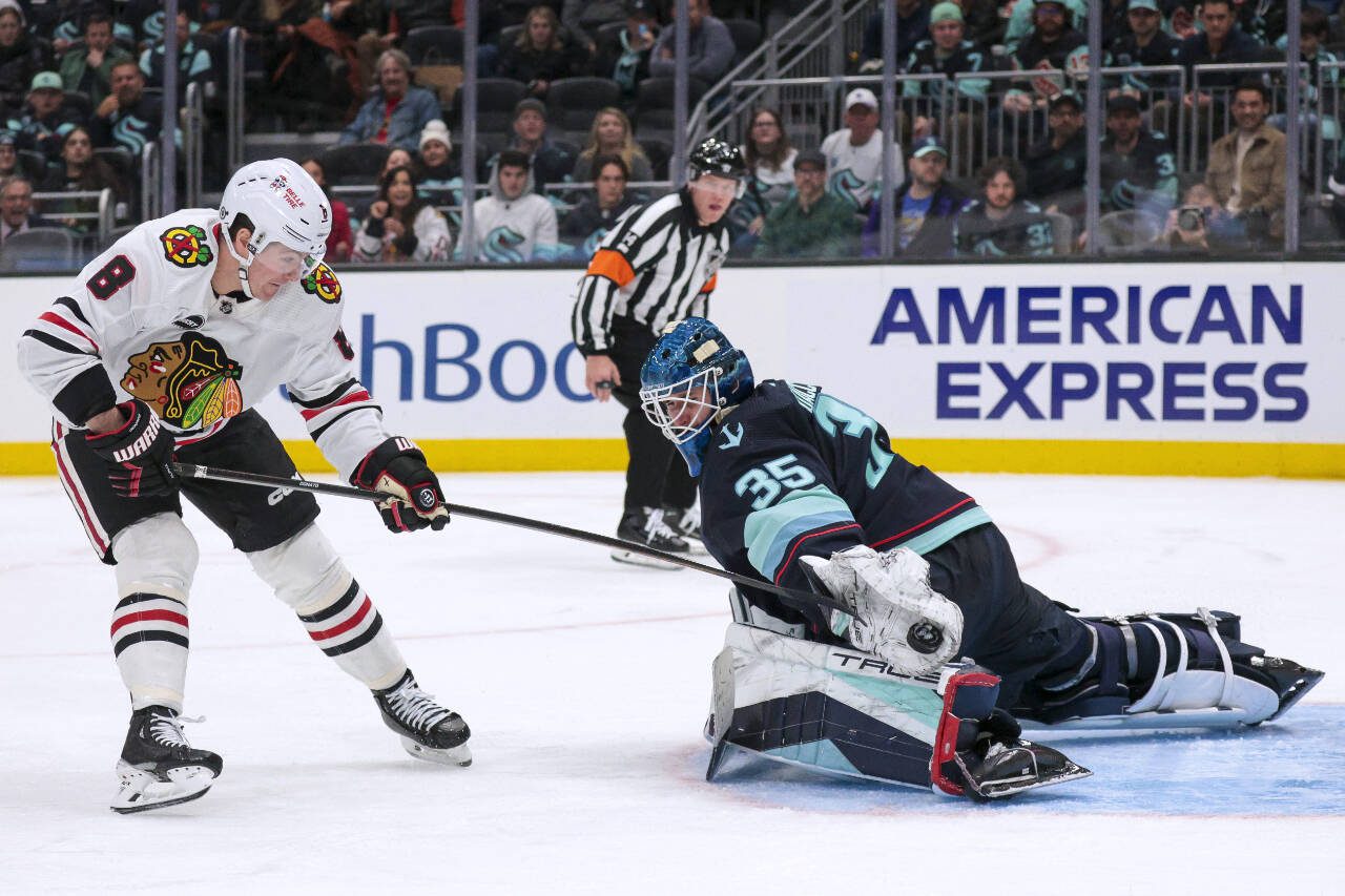 Seattle Kraken goaltender Joey Daccord (35) makes a save on a breakaway by Chicago Blackhawks center Ryan Donato during the third period of a game Wednesday in Seattle. (AP Photo/Jason Redmond)